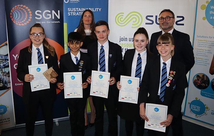 Students from the Renewabus team standing with their mentors, holding certificates 