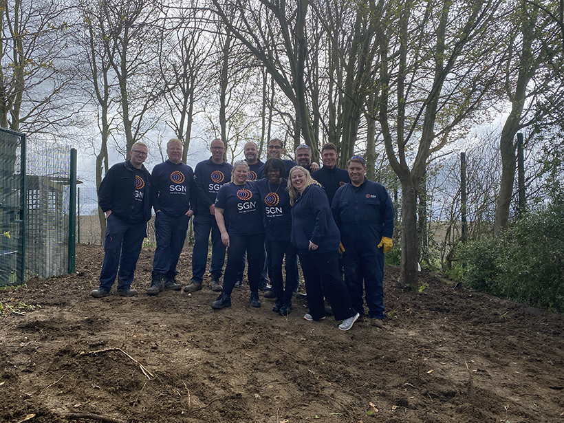 Eleven volunteers from our Southern Construction on site at Helen Allison School after helping to transform its conservation area