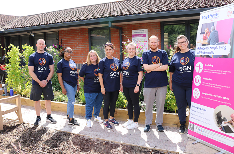 The seven SGN volunteers in the new garden at Sage House Dementia Support near Chichester