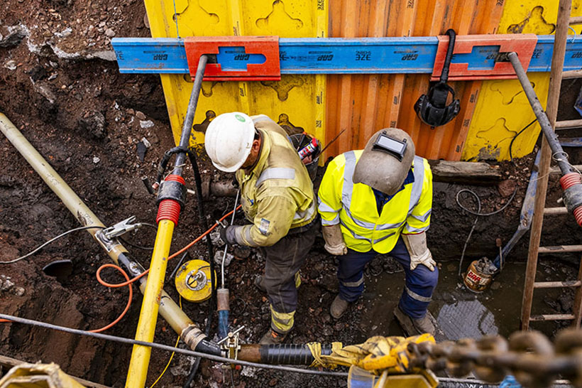 Two gas engineers working in an excavation 