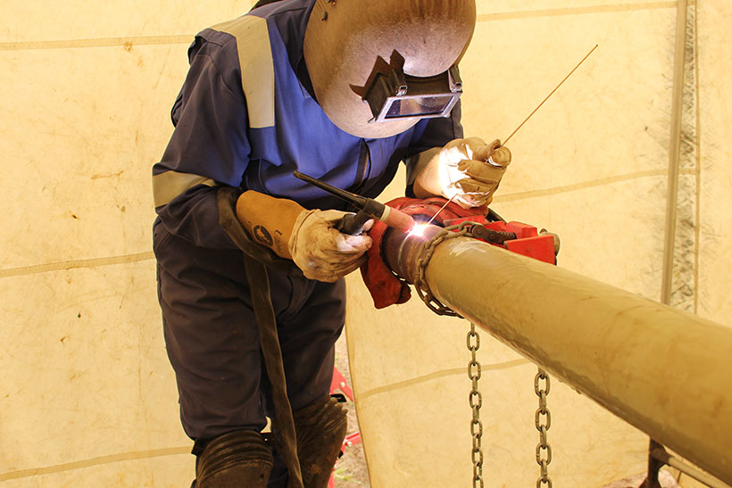 A welder welding a pipe