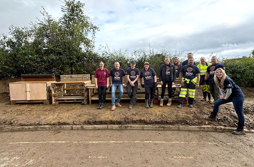 The volunteers from SGN with the completed mud kitchens made from wooden pallets