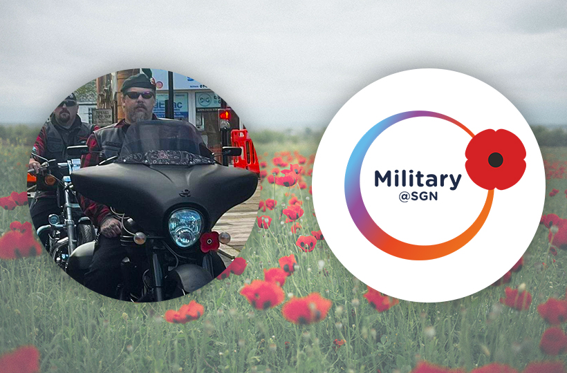 A man on a motorbike on a backdrop of a field of poppies