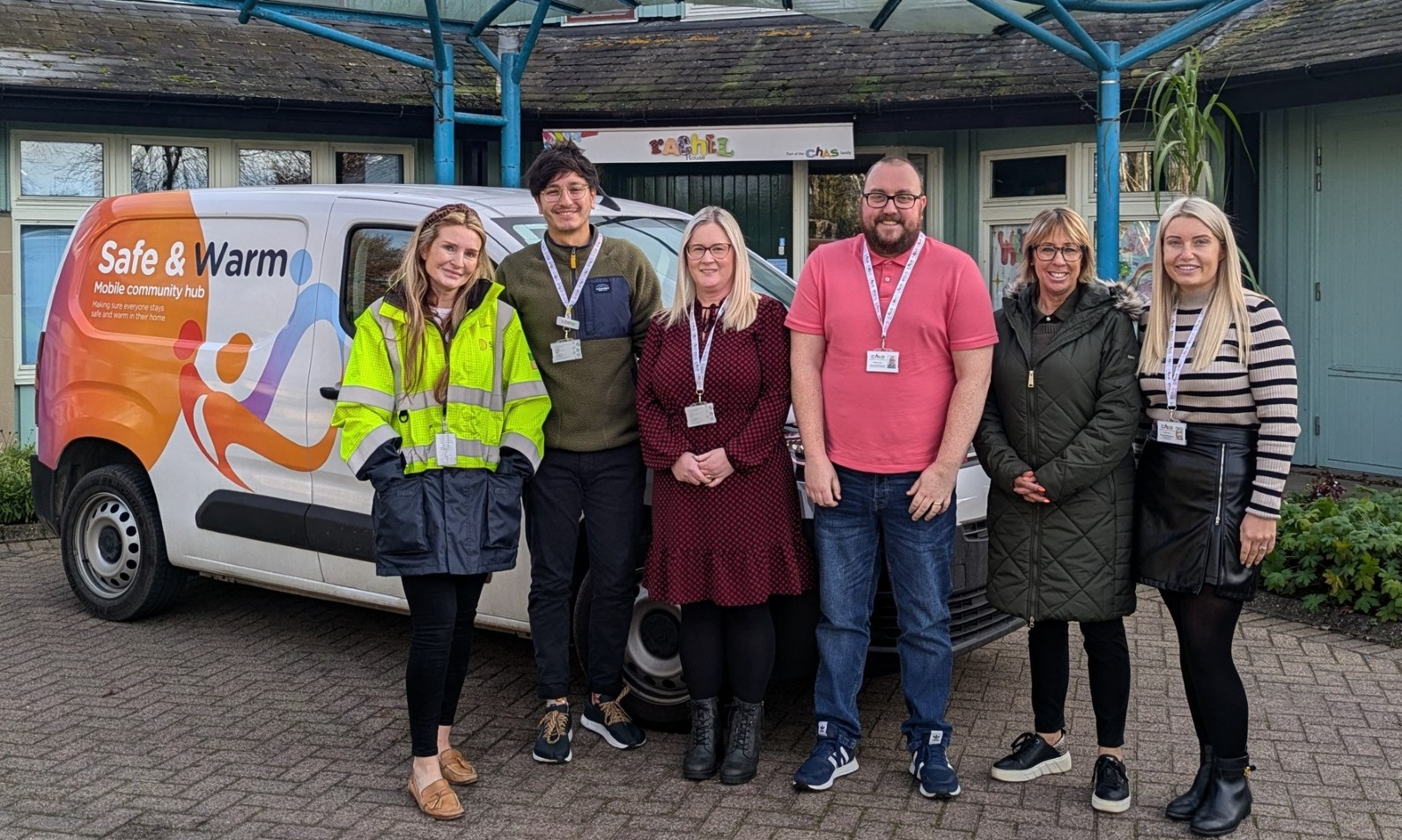 Our SGN team and the CHAS Financial Wellbeing and Energy Advice team are standing in front of a SGN-branded van parked outside a CHAS location