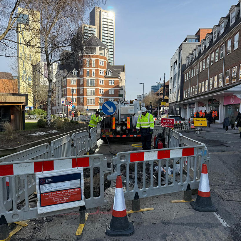 SGN engineers at a roadworks site removing water that entered the gas network