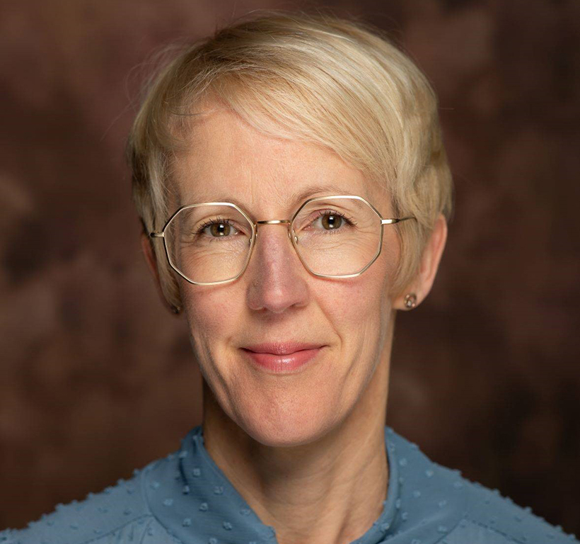 Head and shoulders image of Emily Smith as SGN's new General Counsel. She wears glasses and business attire.