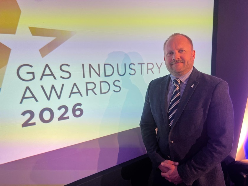 SGN's Ollie Machan standing in front of a screen at the Gas Industry Awards 2026