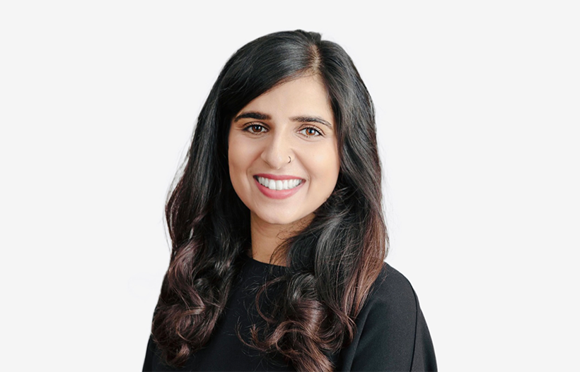 A photo of a smiling woman with a nose ring