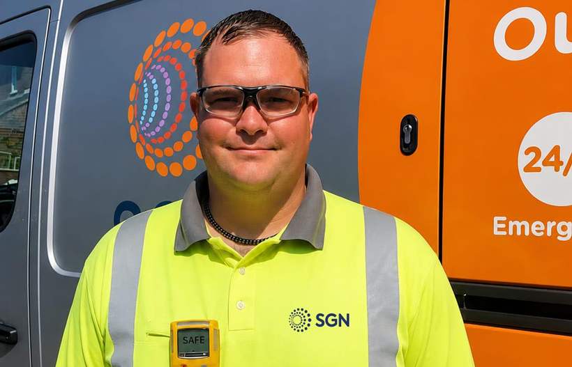 A smiling man in SGN branded PPE