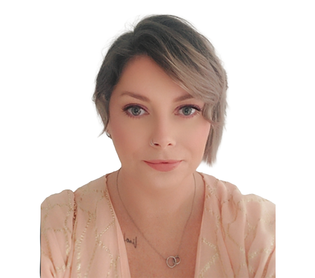 A selfie of a white woman looking at the camera against a blank background