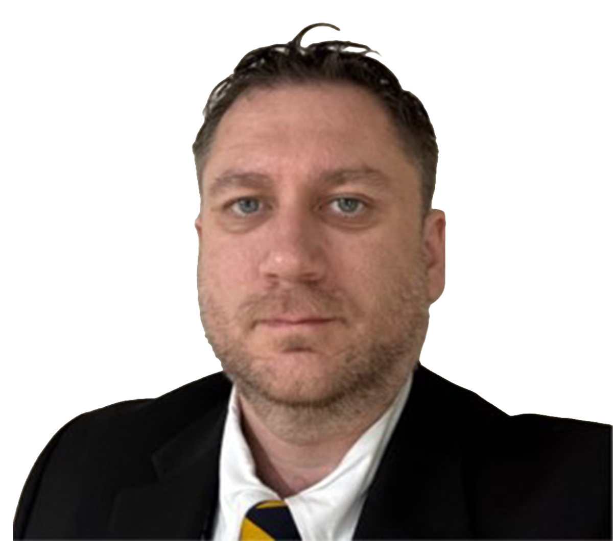 A selfie of a white man looking at the camera against a blank background