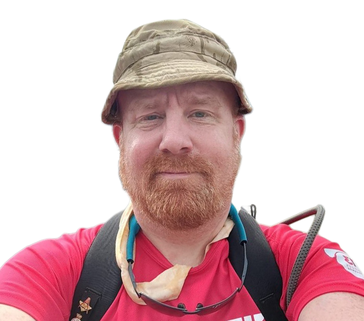 A selfie of a white man looking at the camera against a blank background