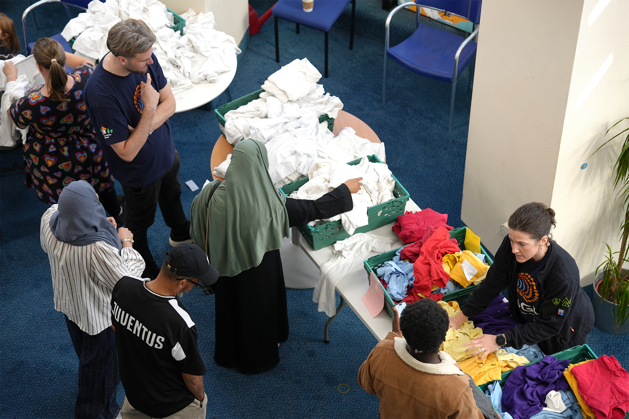 SGN volunteers helping parents look through school uniform items