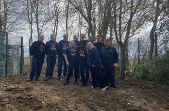 Eleven volunteers from our Southern Construction on site at Helen Allison School after helping to transform its conservation area