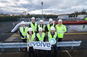 Senior executives in hi-vis and safety helmets on site at Granville Eco Park where Evolve launched the first biomethane-to-grid plant in Northern Ireland