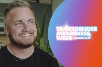 A man smiling looking off camera. Logo for Transgender Awareness Week against a blue, purple and orange gradient.