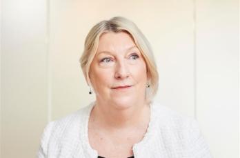 Head and shoulders image of Penny Meddes, Chief People Officer at SGN. She wears business attire and is looking into the distance.