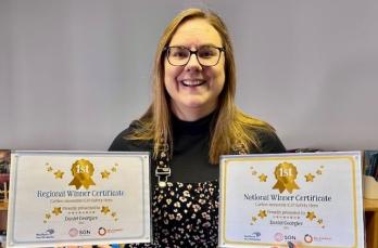 Headteacher Katie Willis ready to present Daniel with his winner’s certificates 