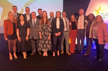 SGN employees standing in front of large display screens at the 2026 Gas Industry Awards after winning three awards